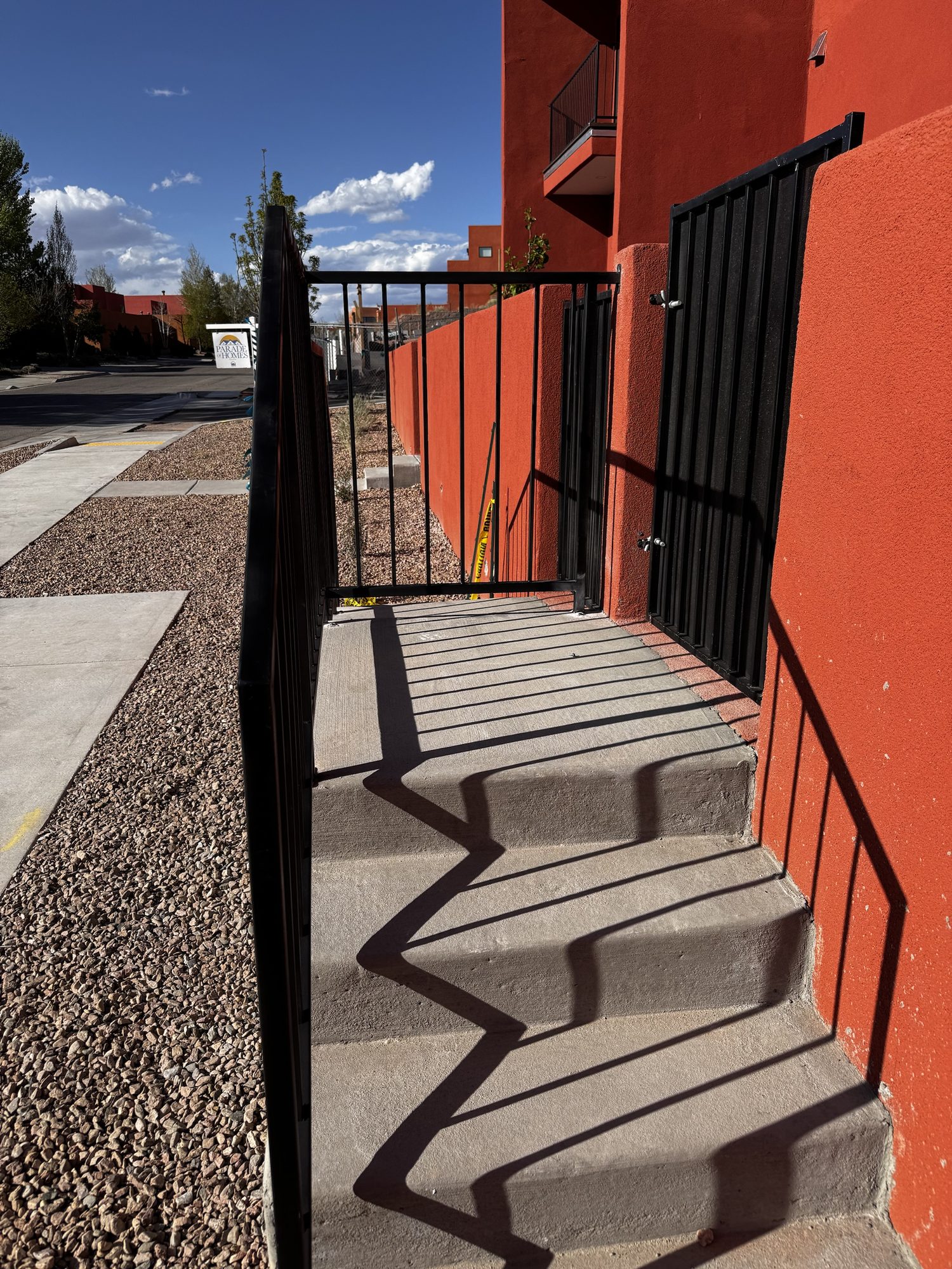 Black steel handrail fabricated and installed along exterior concrete stairs