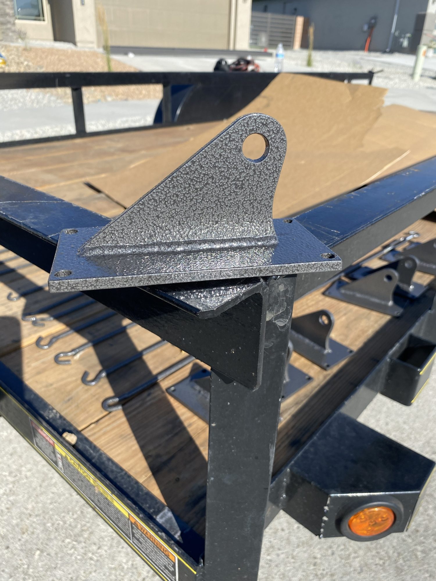 Close detail of a custom welded steel bracket and base plate